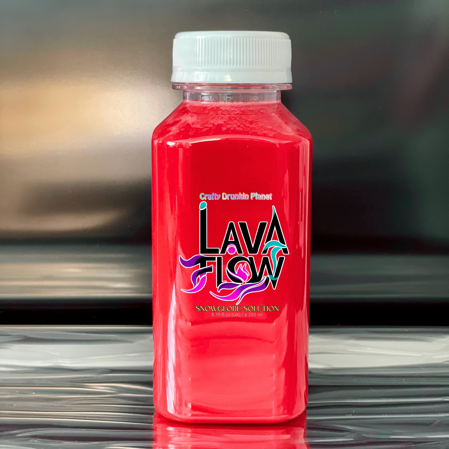 apple Red bottle labeled 'Lava Flow' on a reflective surface with a blurred background