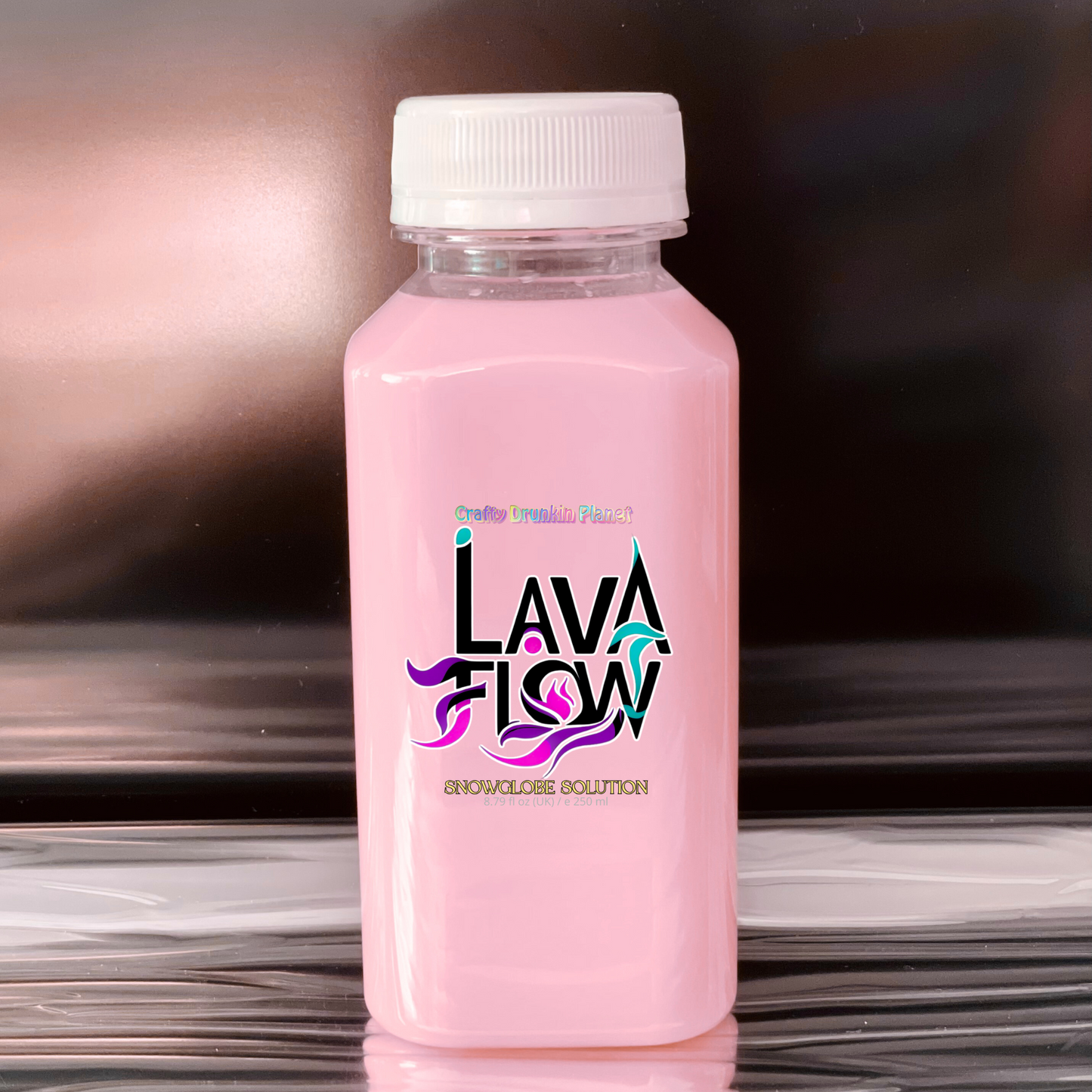 Pink bottle labeled 'LAVA FLOW' on a reflective surface with a blurred background