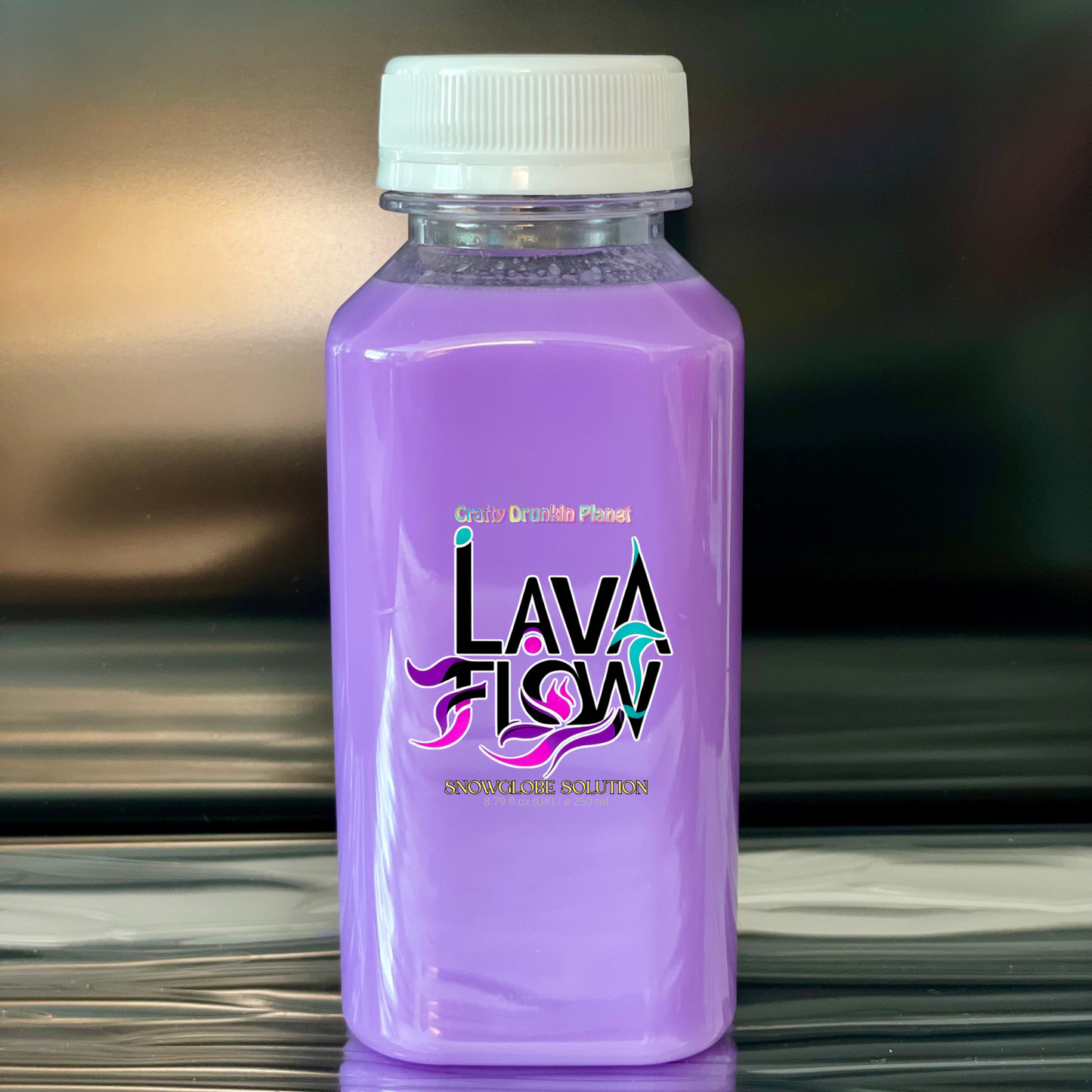Lavender Purple bottle labeled 'Lava Flow' on a reflective surface with a blurred background