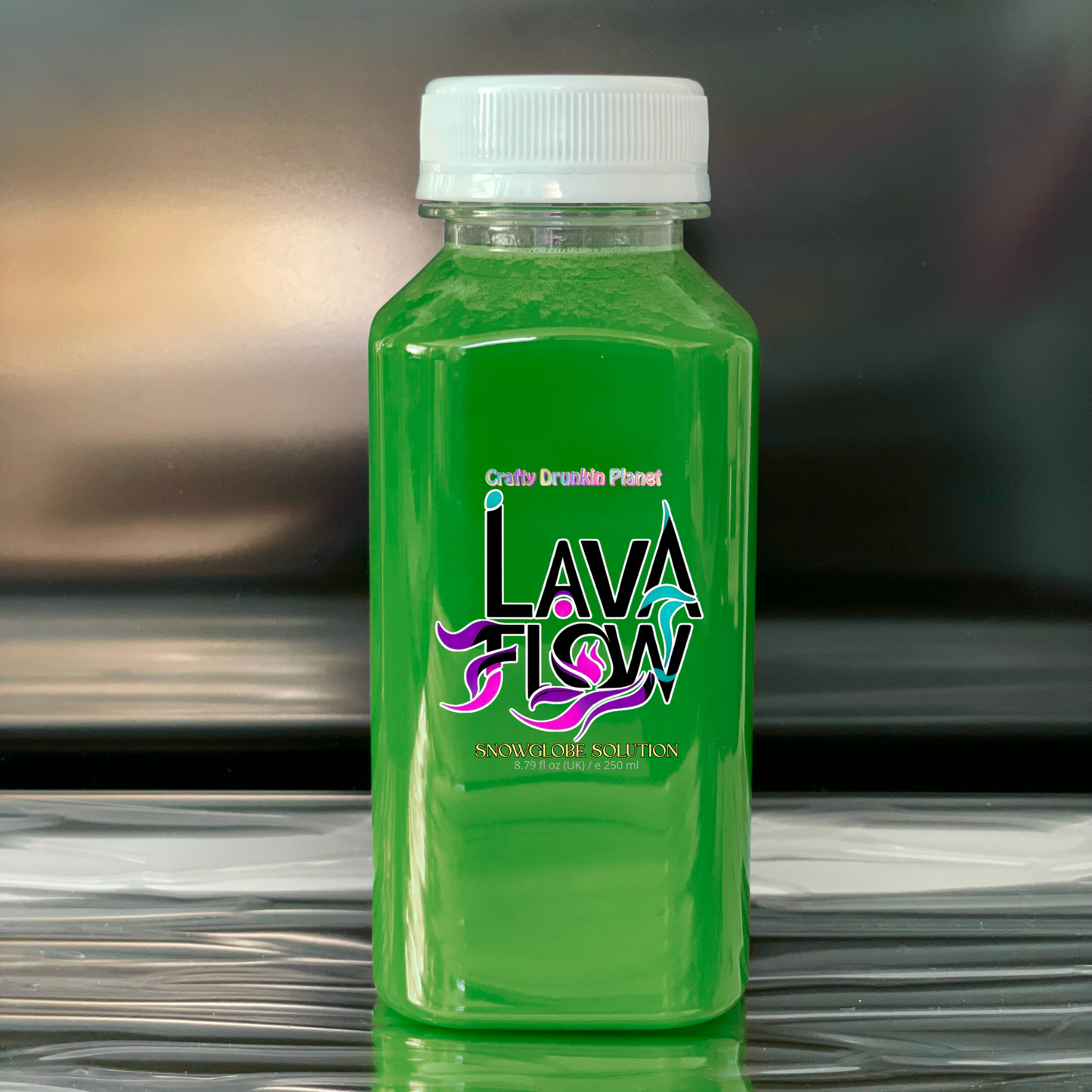 Green bottle labeled 'Lava Flow' on a reflective surface with a blurred background