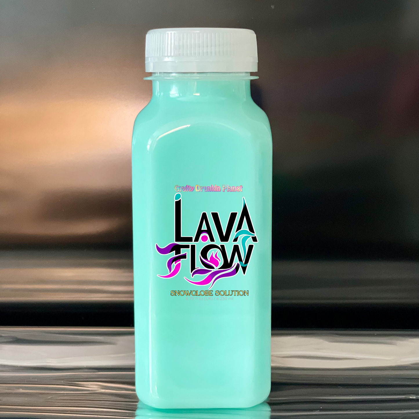Turquoise bottle labeled 'Lava Flow' on a reflective surface with a blurred background
