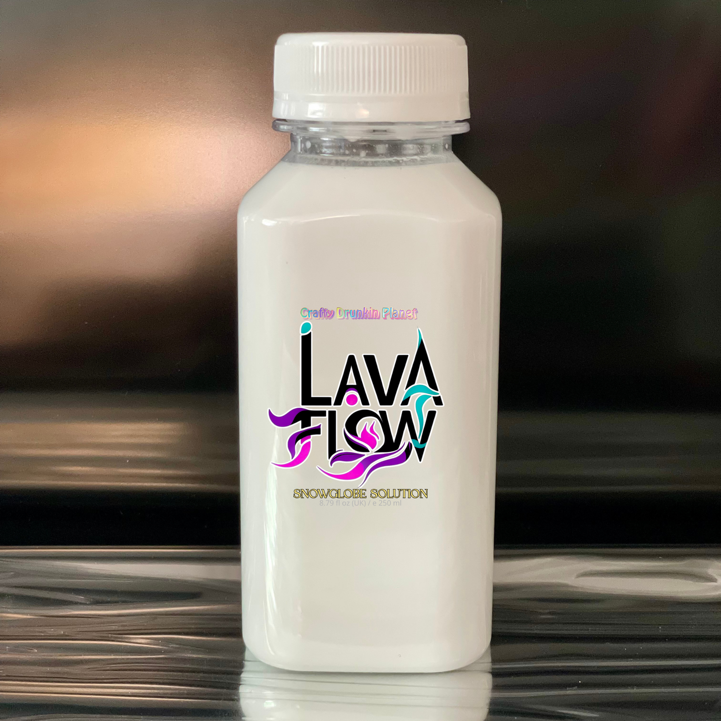 White bottle with 'Lava Flow' logo on a reflective surface with a blurred background