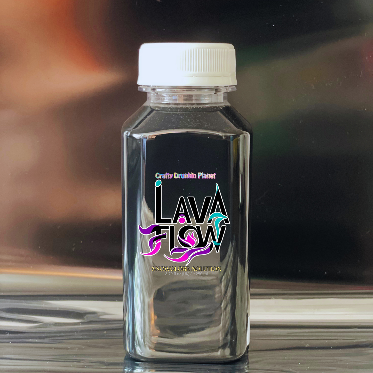 Black bottle labeled 'Lava Flow' on a reflective surface with a blurred background