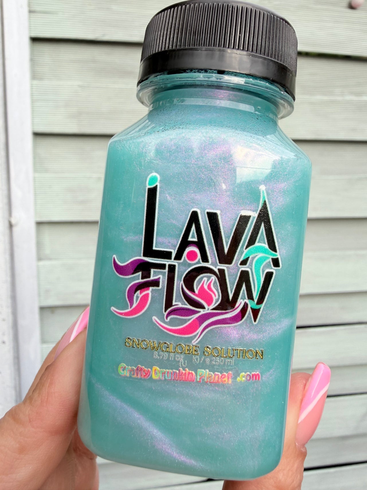 Turquoise with aurora shades bottle with 'Lava Flow' branding .