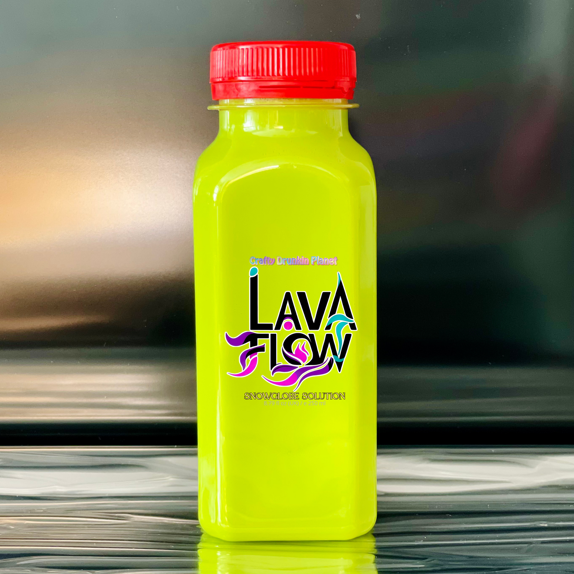 citrus green bottle with red cap labeled 'Lava Flow' on a reflective surface.