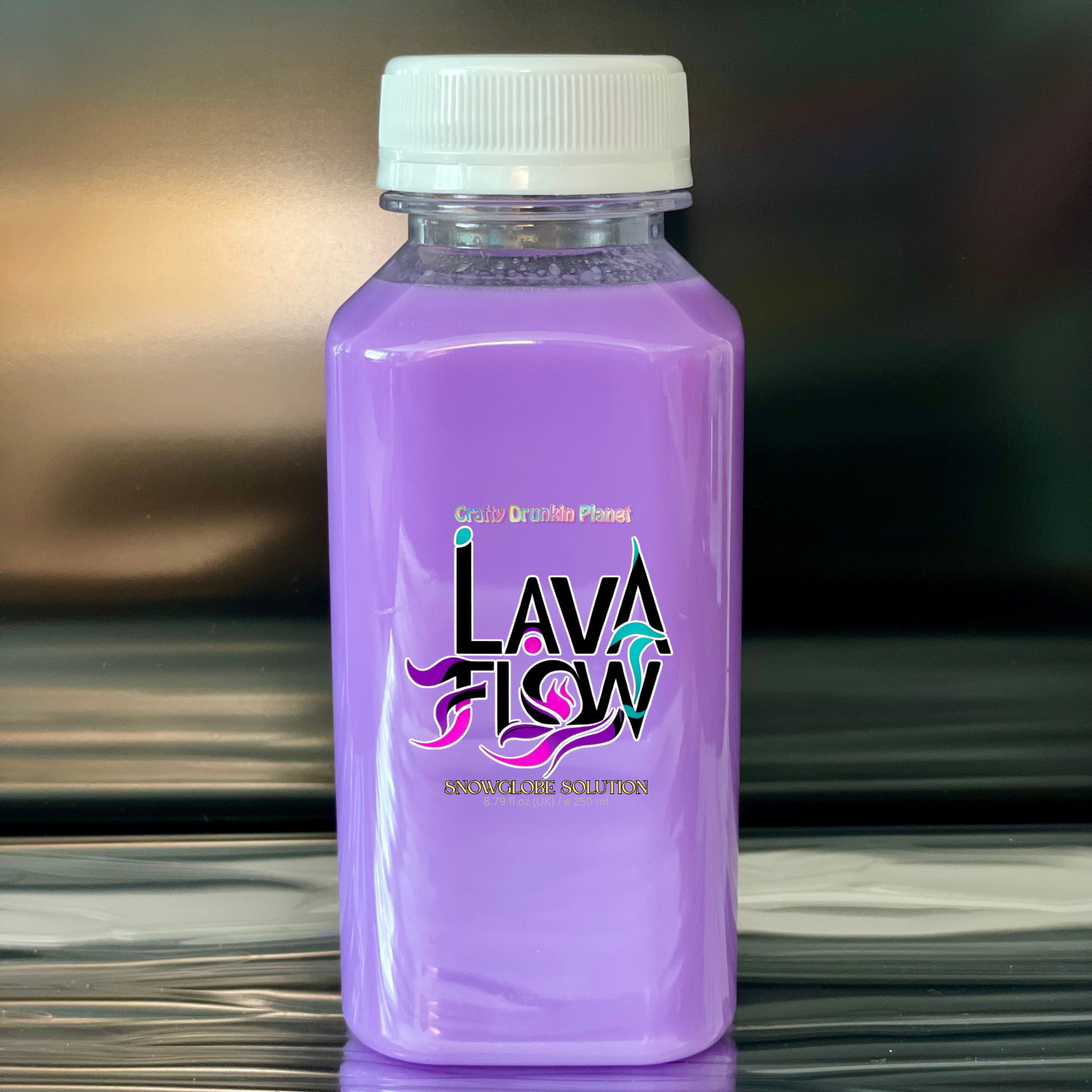 Lavender Purple bottle labeled 'Lava Flow' on a reflective surface with a blurred background