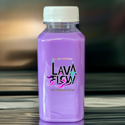 Lavender Purple bottle labeled 'Lava Flow' on a reflective surface with a blurred background